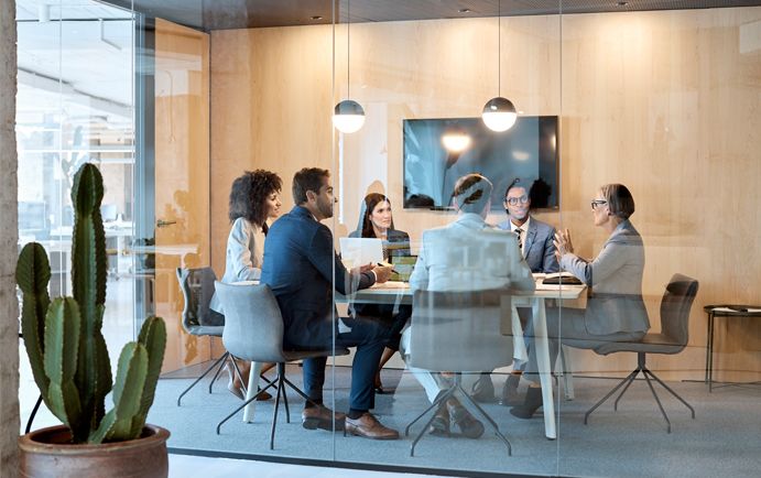 Six people working in a meeting room